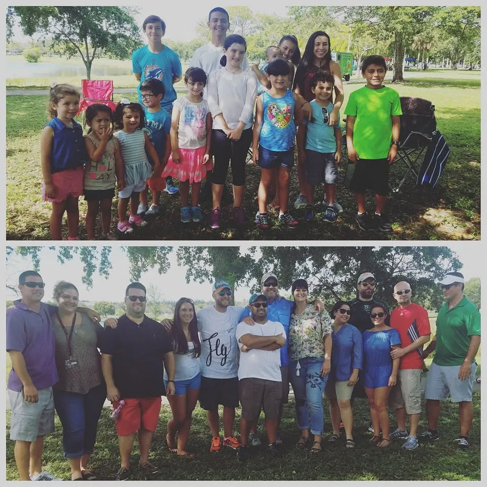 Class picnic group photo, kids in front, parents behind