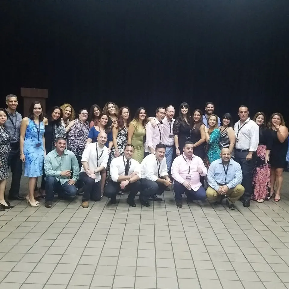 A big reunion group photo, everyone dressed up