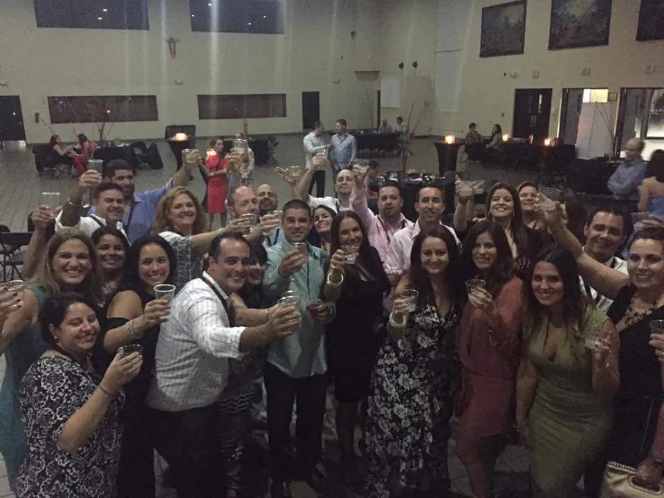 Classmates crowded in for a photo at a reunion