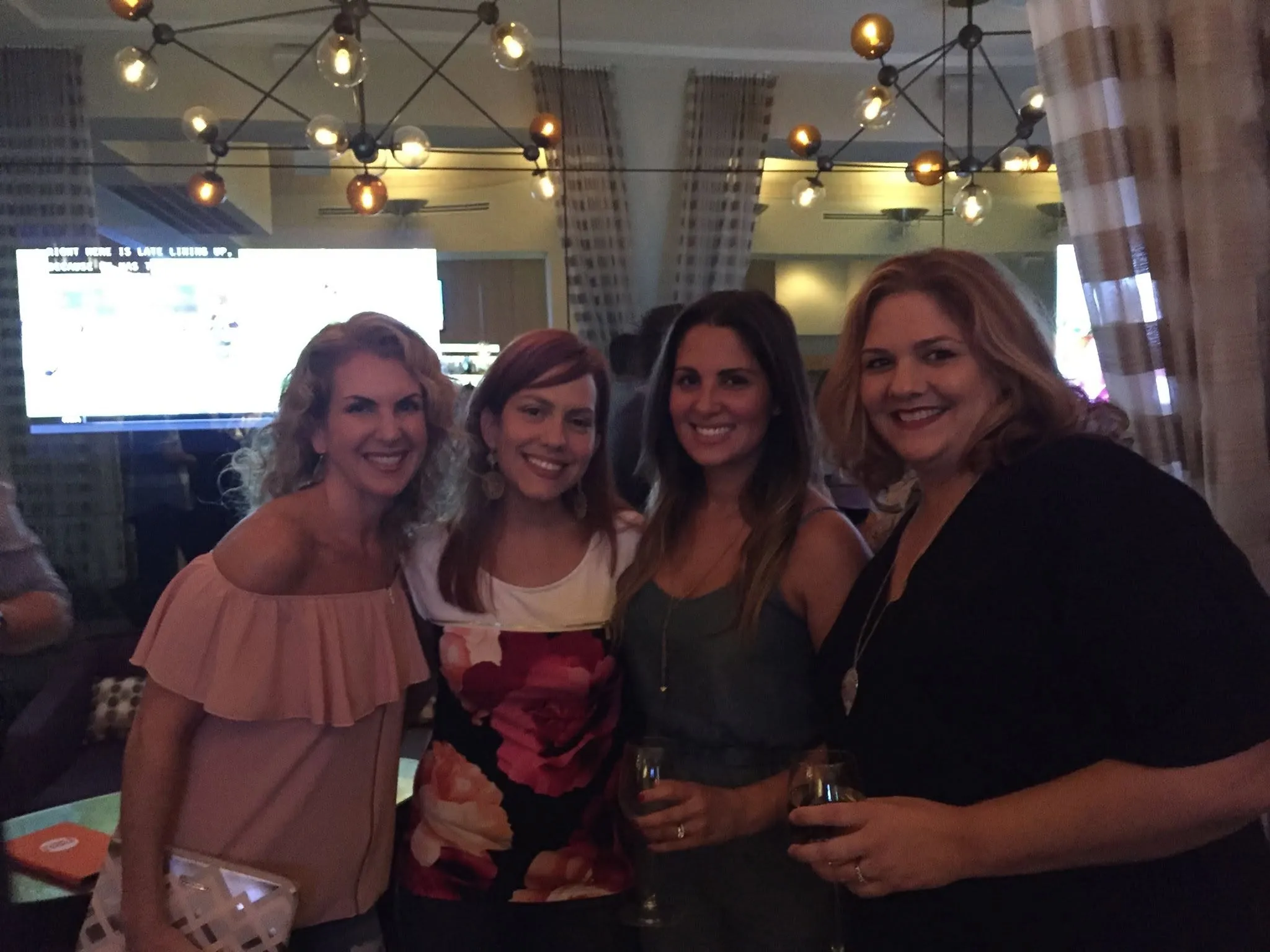 Four friends at a bar