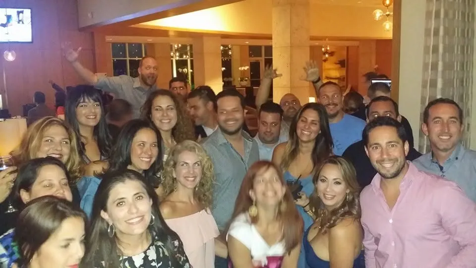 A packed group of classmates at a restaurant night out