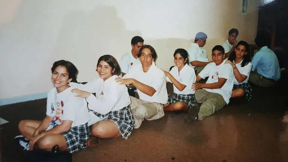 Classmates in uniform sitting on the floor