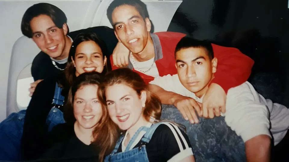 Five classmates piled together for a photo
