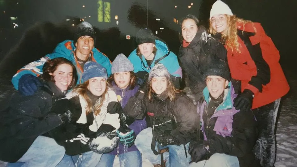 Classmates in winter coats and hats on a trip