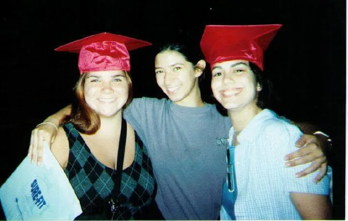 Three friends, two in graduation caps