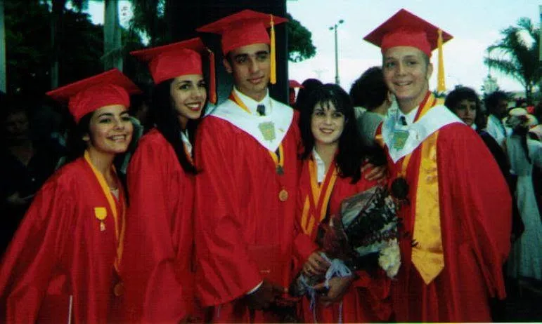 Graduates in red gowns and gold stoles