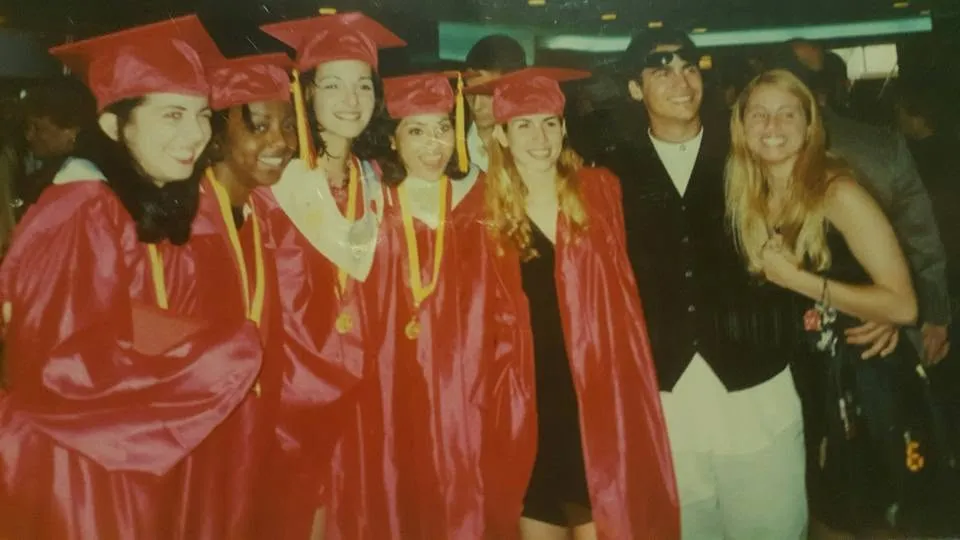 A row of graduates in red gowns